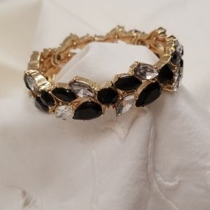 Bracelet with rhinestones and black faceted stones. Gold tone.